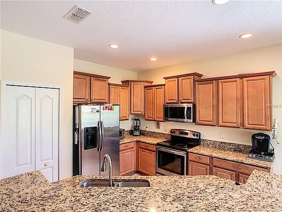 Kitchen with granite counter tops & stainless steel appliances