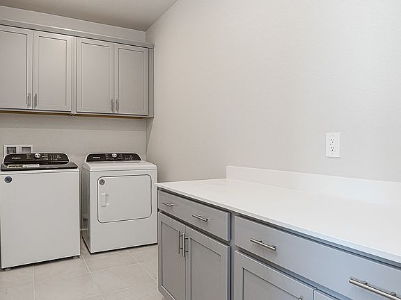 Spacious laundry room with plenty of storage.