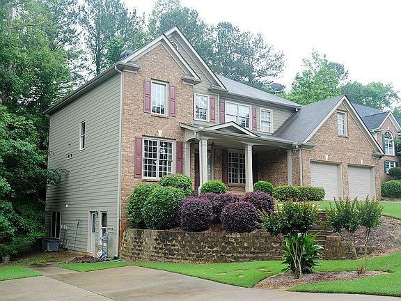 Side view showing basement entrance and lower driveway
