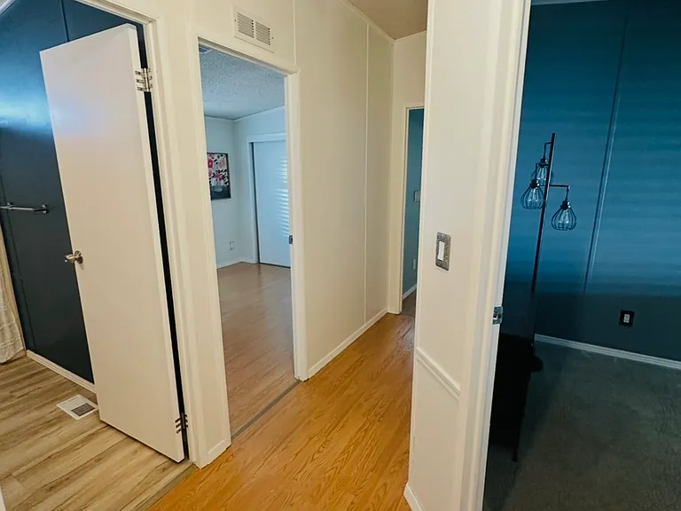 Hallway: Second bedroom on right, full hall bathroom immediate left, second left is third bedroom and master down the hall.