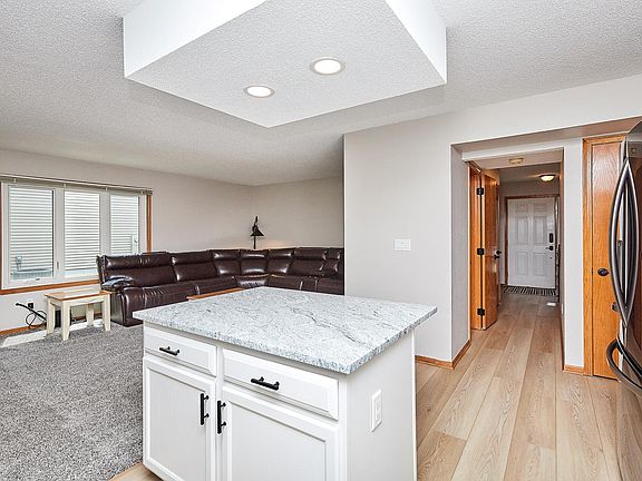 Kitchen is at the end of main floor hall. New flooring throughout the house.