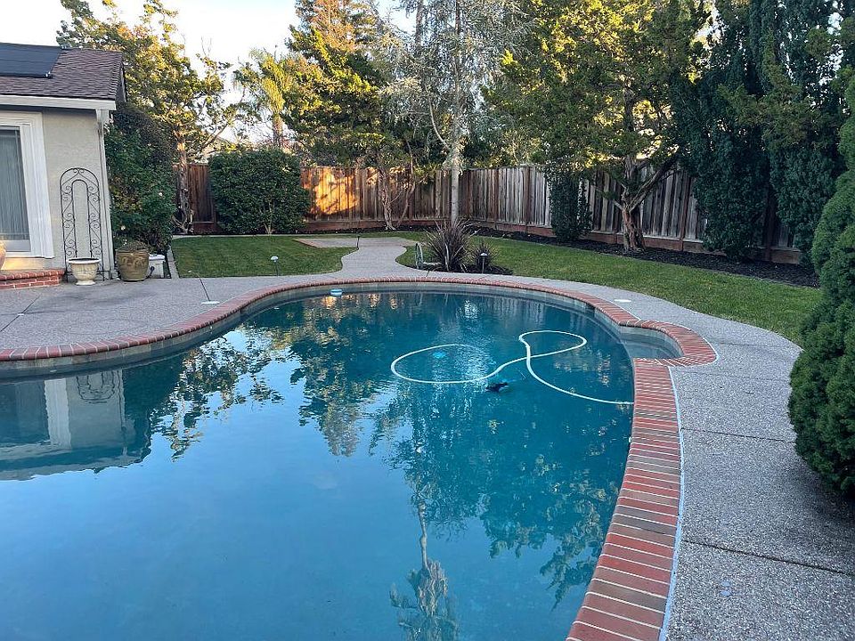 pool and yard with high fence for privacy