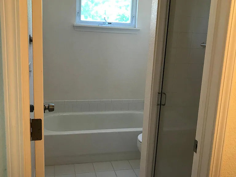 Upper floor primary bathroom with shower and full sized tub