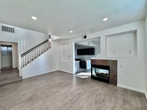 Living room with vinyl flooring and fireplace