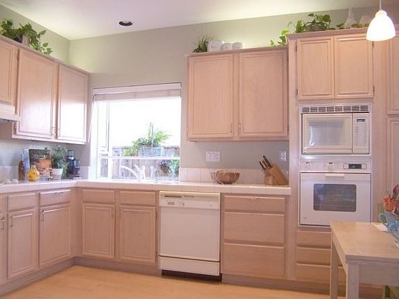Light and Bright Kitchen with Hardwood Floors, Champagne Oak Cabinetry, and Recessed Lighting