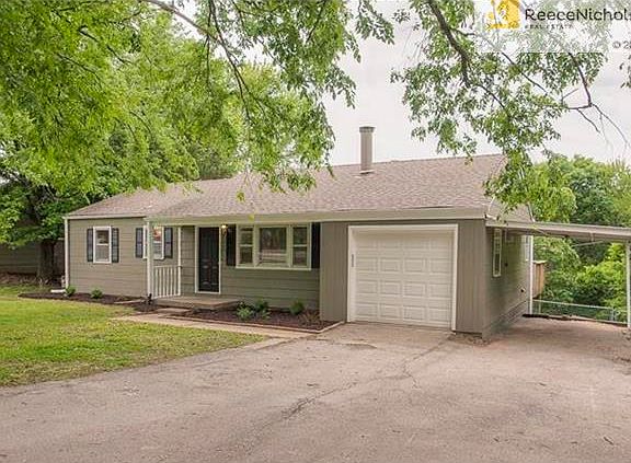 Large driveway with a brand new garage and keypad plus a carport.