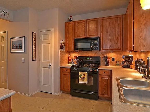 The kitchen is a chef's dream with a gas stove, 42" cabinets, under cabinet lighting, and silestone countertops.