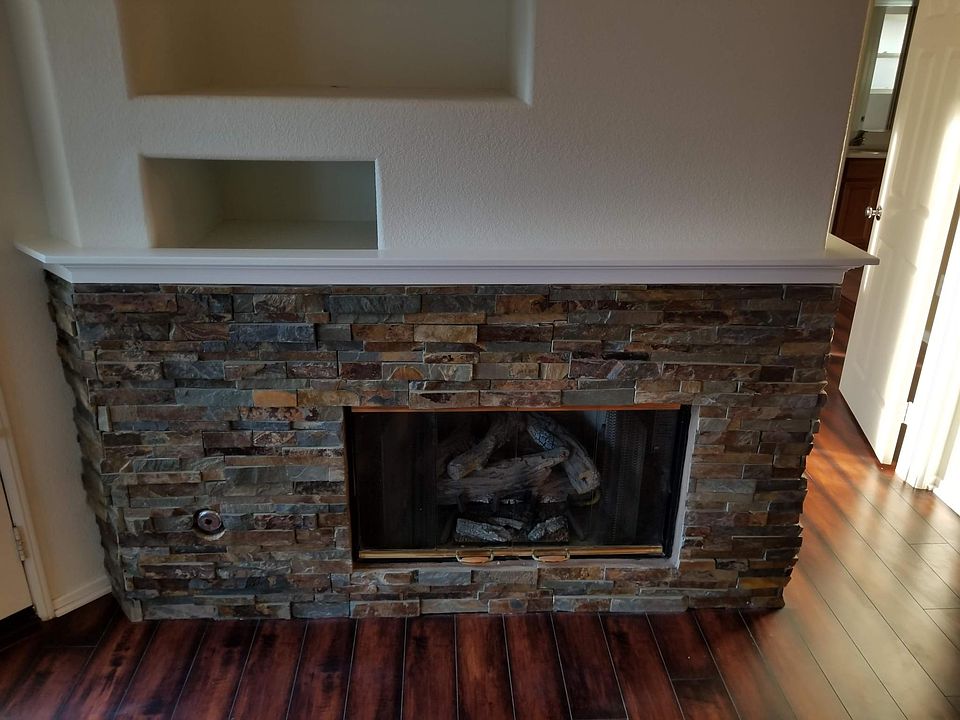Stacked stone fireplace with gas fireplace insert