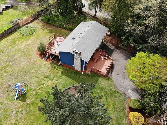 Home is on a spacious, flat yard with wrap around driveway and front and back decks.