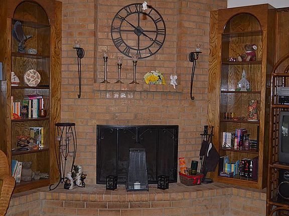 The fireplace visually anchors the room. It is wood burning and has a gas connection.