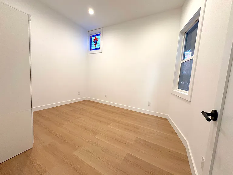Bedroom 2 with stained glass accent window