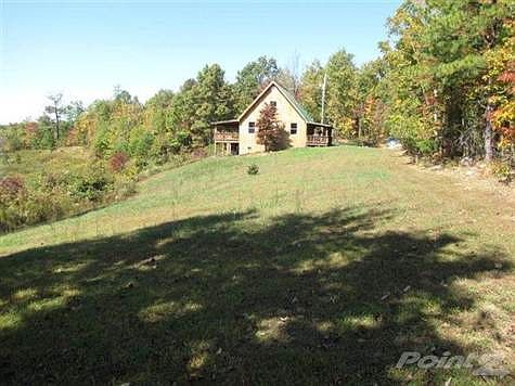 180+- ACRES with a 3BR home. This is picture of the home before the garden plots were made. The plots are now established and producing. There is something here for everyone.  Especially if you'd like to be self-sufficient.  The beginning plan is already in place--all you have to do is follow it.  It is a wildlife haven with streams and low foliage!There are pastures, some cleared, some not which will hold cattle, horses, alpacas, your choice.It is an easy accessible large plot of land which you usually only find so remote that it is difficult to get there without a four-wheeler.  This property has a paved road right to the driveway yet it is very private!   SEE VISUAL TOUR!