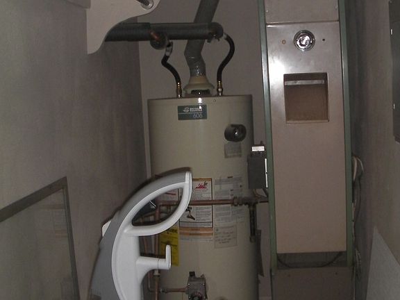 Storage closet with furnace and coat rack