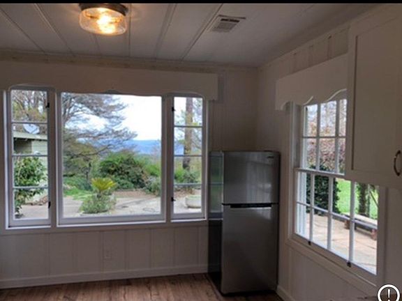 Kitchen with gas range, fridge, new cabinets and marble countertops