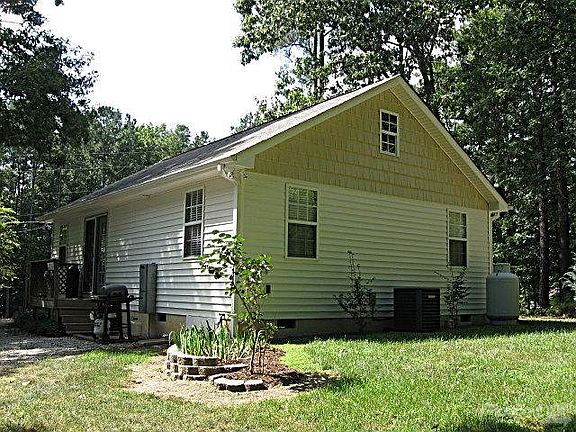 Side porch entry into kitchen leads out to nice flat yard for playing and entertaining!