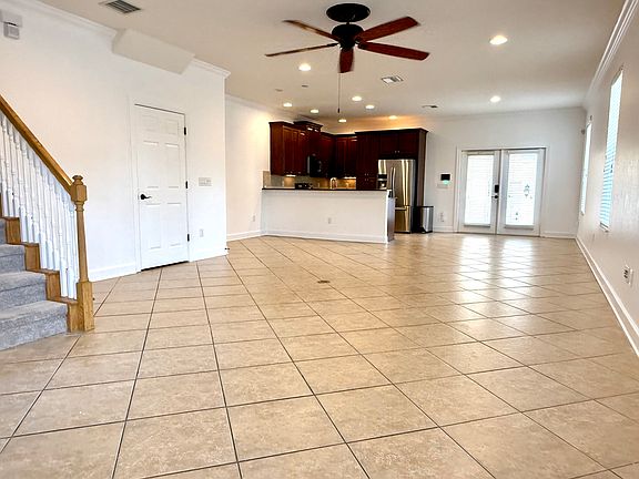 The grand room is bright and airy and has room for an entry foyer, living room, dining room, breakfast nook, and kitchen. 1/2 bath to the left.