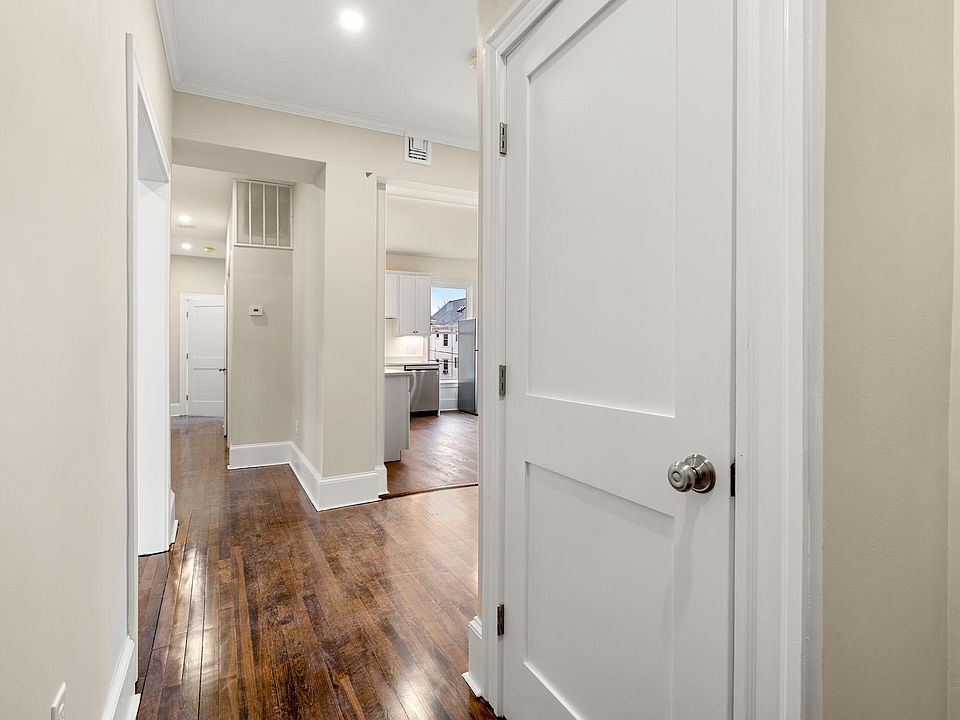 View inside front door - looking at coat-closet and down hallway