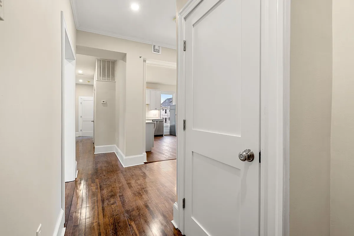 View inside front door - looking at coat-closet and down hallway - 10 King St #2