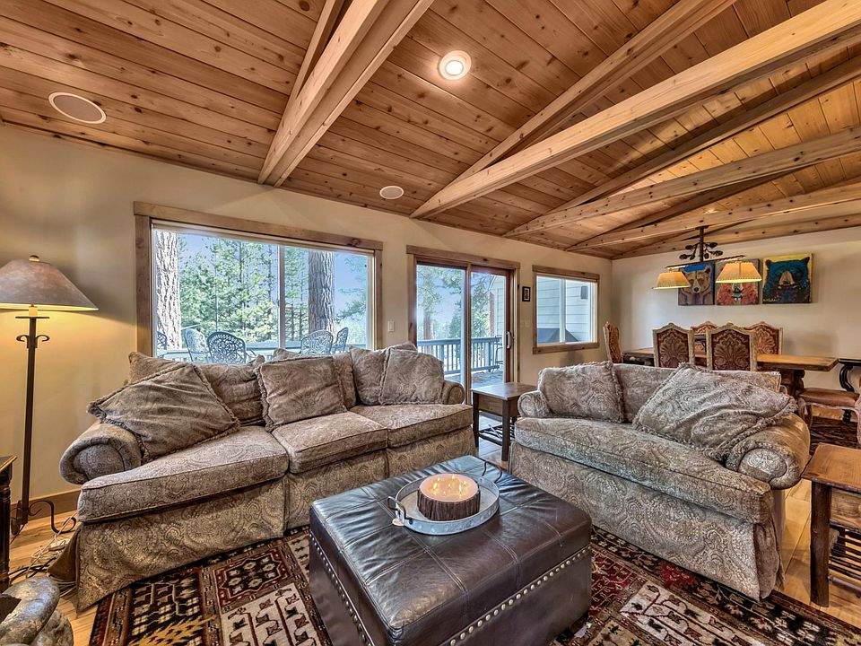 Cozy living area with recessed lighting on dimmer switch.