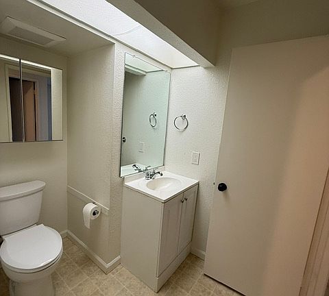 1/2 bath, toilet and sink with storage.