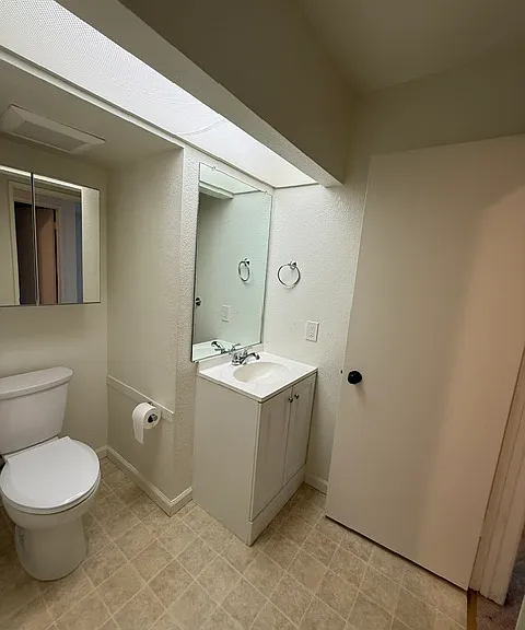 1/2 bath, toilet and sink with storage.