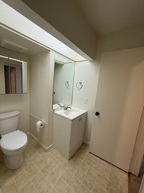 1/2 bath, toilet and sink with storage.