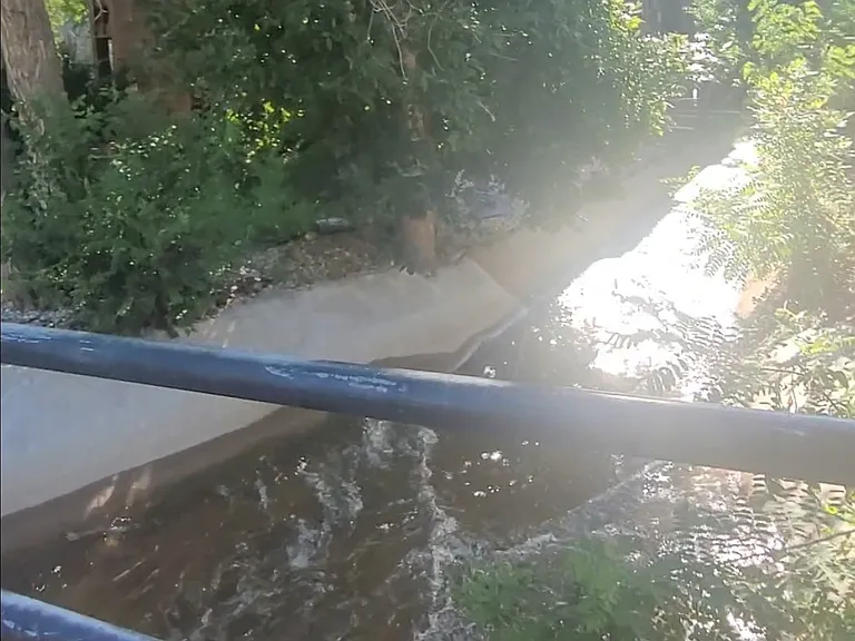 Stream behind adjacent building