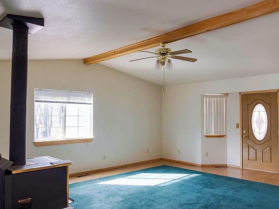 Living room with vaulter ceilings and wood burning stove
