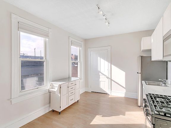 Kitchen and partial view of dining area (island cart on wheels for easy reconfiguring)