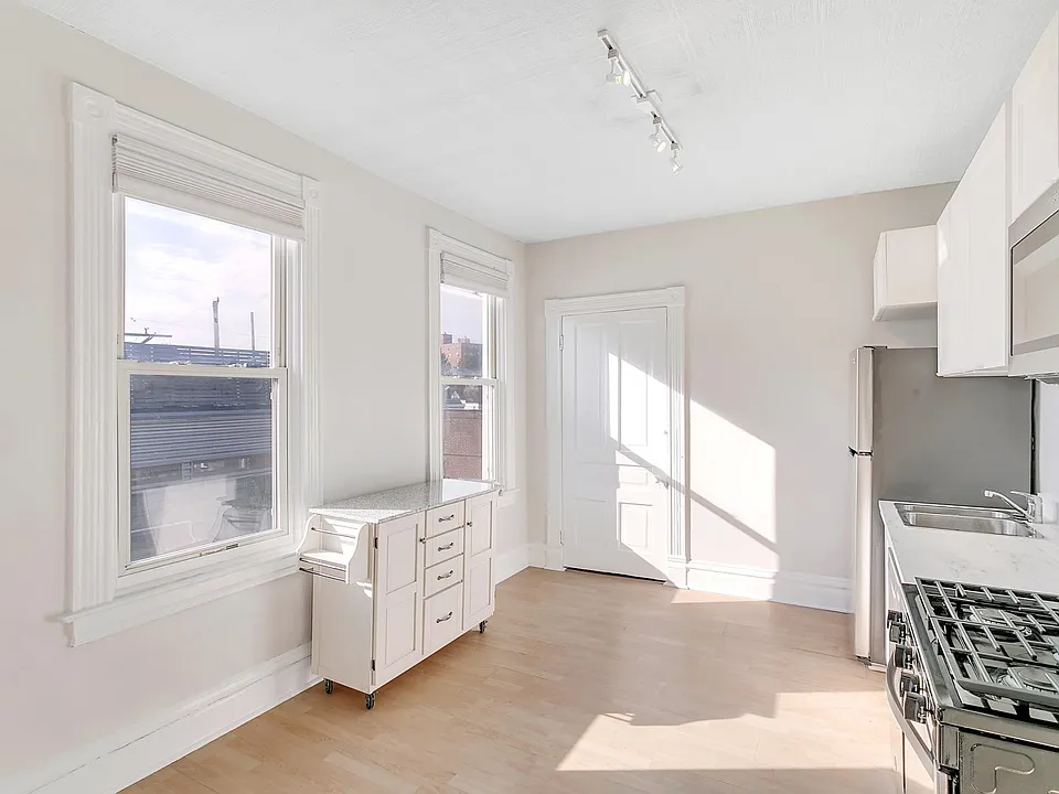 Kitchen and partial view of dining area (island cart on wheels for easy reconfiguring)