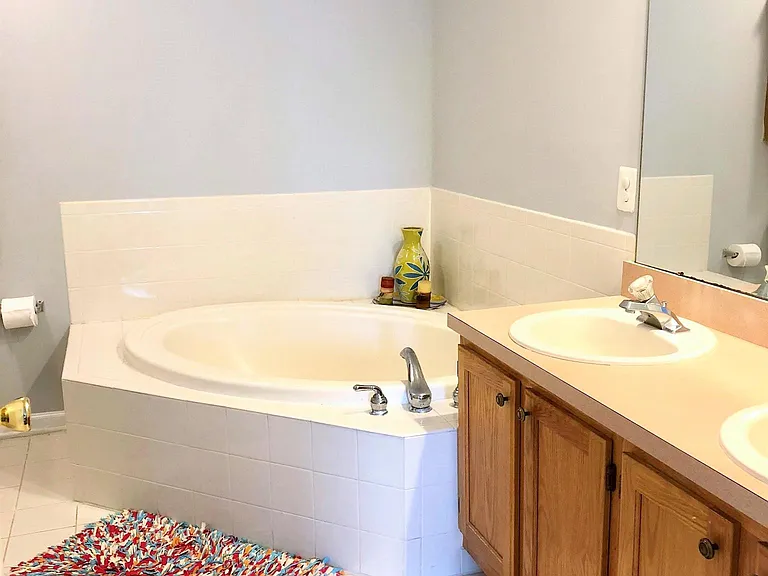 Master bathroom with tub, double sink and stand up shower.
