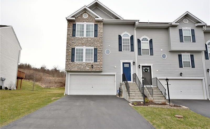 Great curb appeal! Beautiful stone and vinyl exterior.  Well maintained end unit.