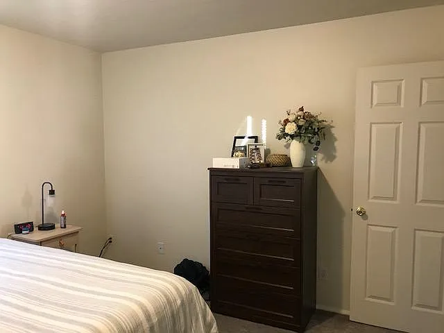 Lots of space is available in this master bedroom even with a king-sized bed. By the way, there is plenty of space on the other side of this king-sized bed and also at it's foot. The door pictured is open not closed.