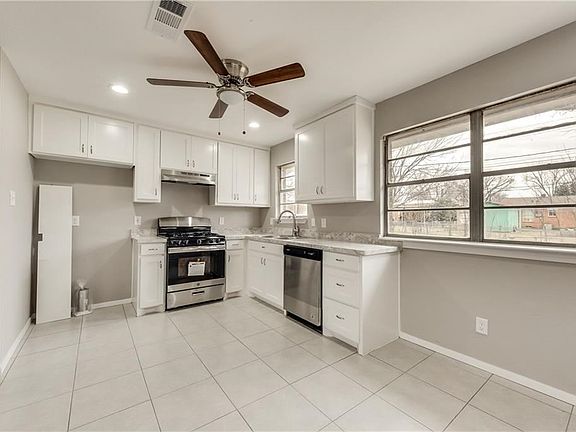 Breakfast area and kitchen with Stainless Steel gas stove and dishwasher just installed.