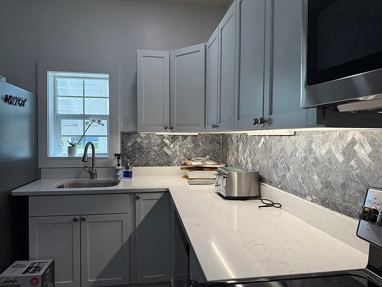 Marble backsplash and under cabinet outlets
Quartz countertops