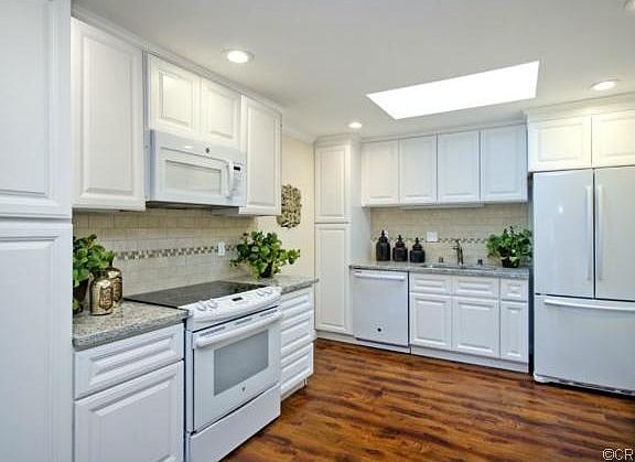 Large kitchen with recessed lighting and natural skylight