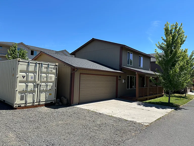 Storage container is for landlord use. 1 parking space in front of container for tenant use in addition to spaces in garage and on garage pad.
