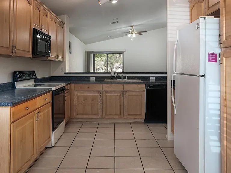 tiled floor kitchen, with natural cherry-wood cabinets (lots of them!)