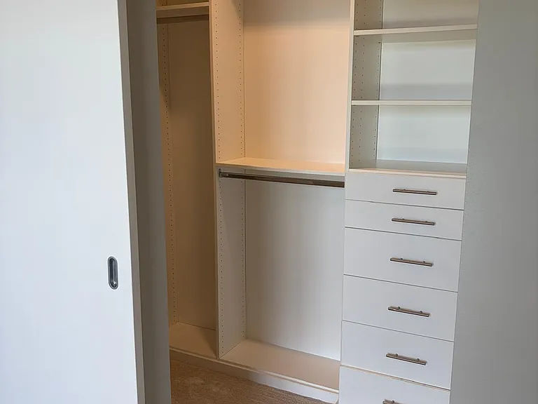 Custom built drawers in walk-in closet