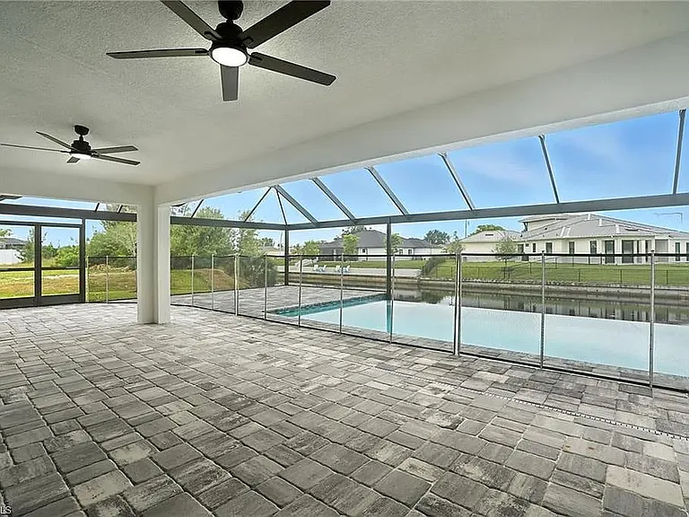 Infinity pool with picture frame cage and child safety fence.