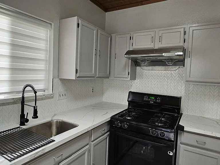 5. Stove-Granite-Kitchen with granite counters, refinished cabinets, new vanity, fixtures, and gas cooking