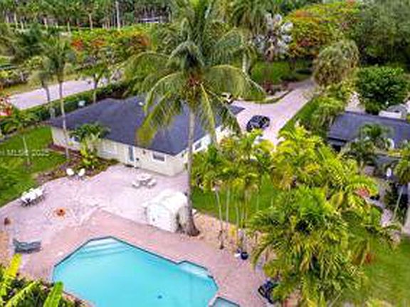 Aerial overview of the tropical estate, showing the landscaped grounds, cottage setting and pool area.