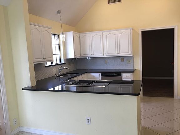 gorgeous galaxy black granite countertops, glass tile backsp