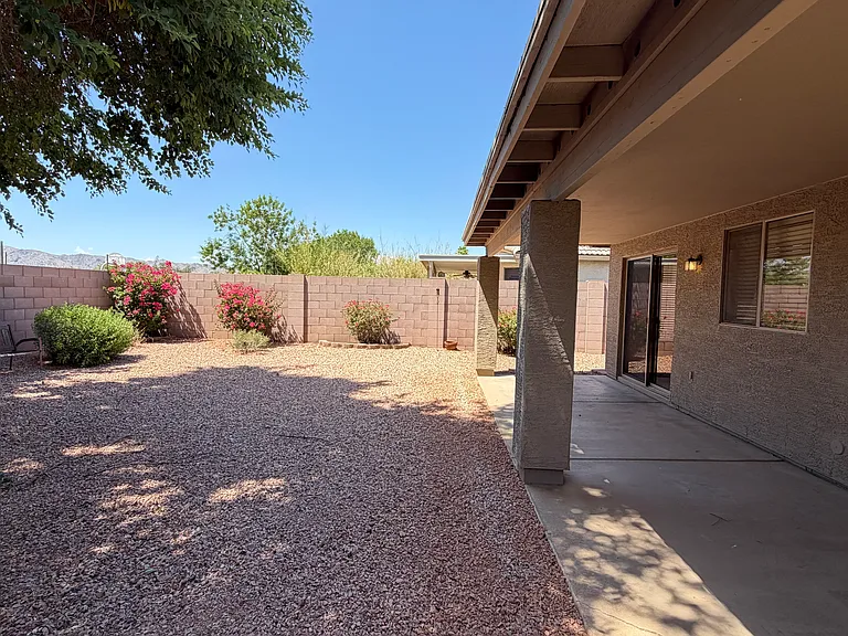 Shady backyard with full covered patio and easy-care landscape