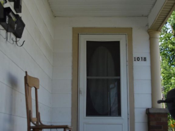 This is the door from the porch to the upstairs 3 units and shared bathroom.