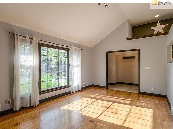 The living room boasts gleaming hardwood floors, a large picture window overlooking the professionally landscaped front yard and soaring ceiling.