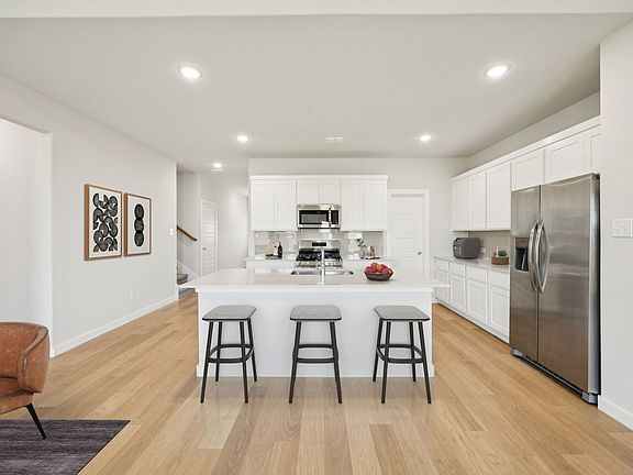 Kitchen in the Masters home plan by Trophy Signature Homes - REPRESENTATIVE PHOTO