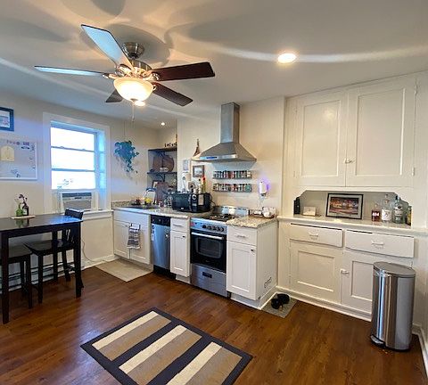 Large bright kitchen with new cabinetry and flooring
