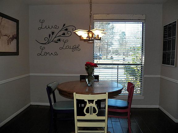 Dining area features chair rail molding and a nice view of your front yard