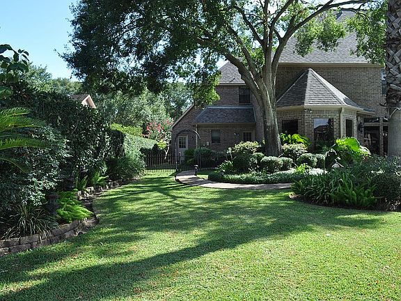 Large backyard w stone path 
to play area/dog run